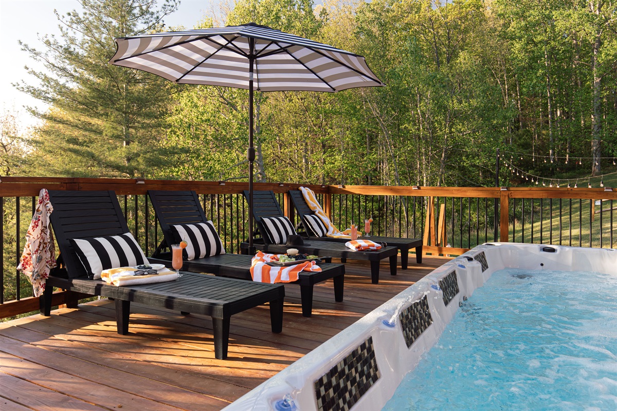 {Pool Deck} Spend slow afternoons poolside, cool off in the swim spa, or lounge on the deck surrounded by peaceful mountain scenery. Designed for relaxation, the swim spa pool can be heated up to 104 degrees or chilled, based only our preference. 