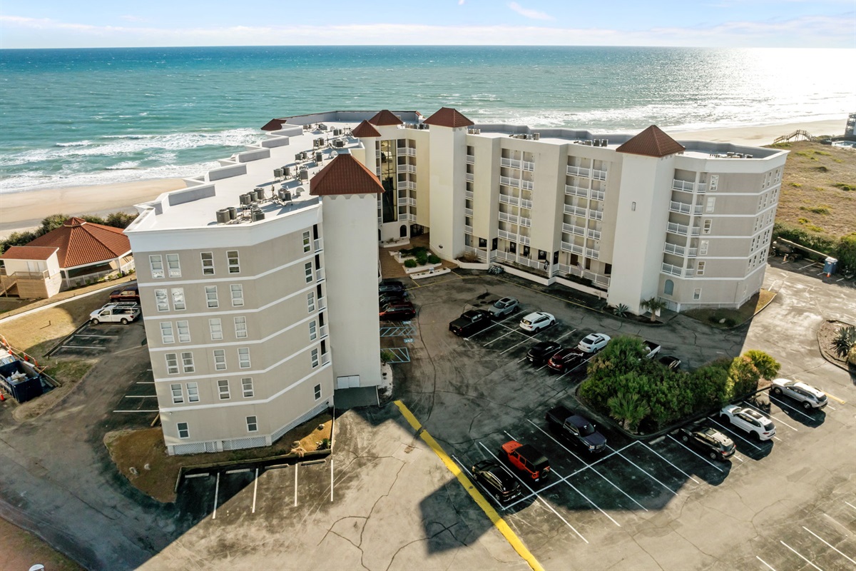 Aerial view of Building 1 at St. Regis, showcasing its oceanfront location, private balconies, and convenient on-site parking just steps from the beach