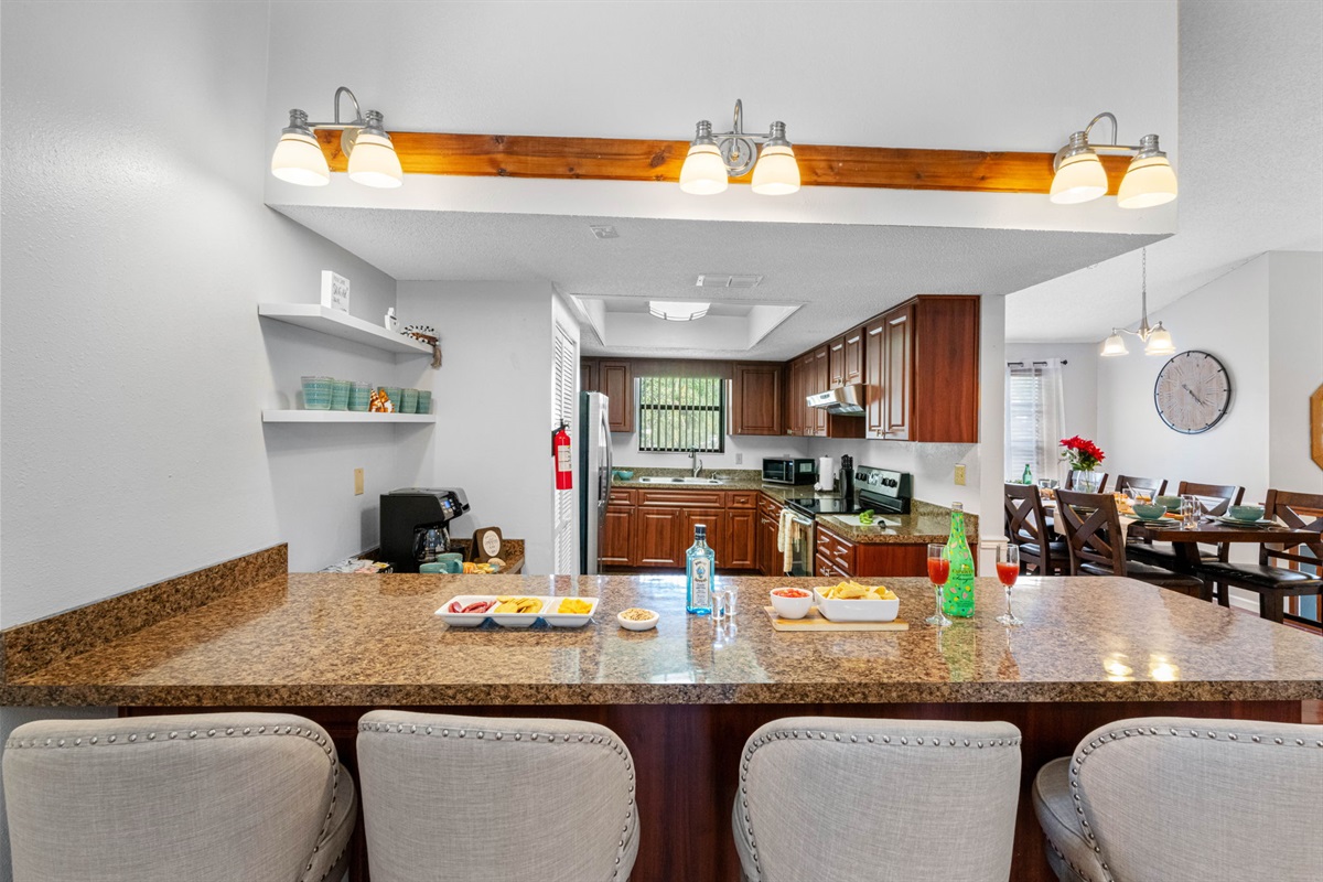 The kitchen’s extended countertops offer bar seating, making it a versatile space for everything from casual bites to entertaining guests.