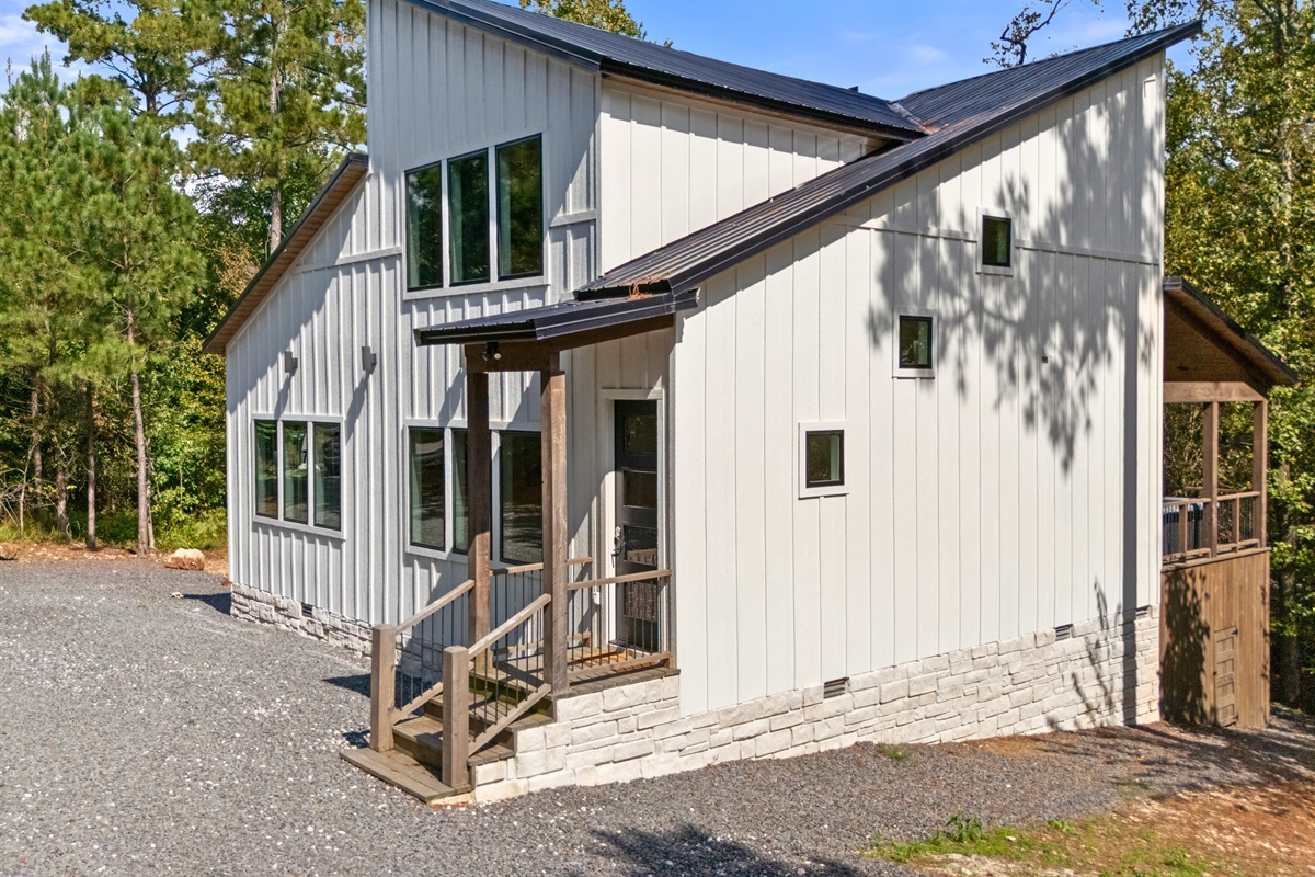 Front exterior of Fishin’ For Fun cabin with gravel drive.