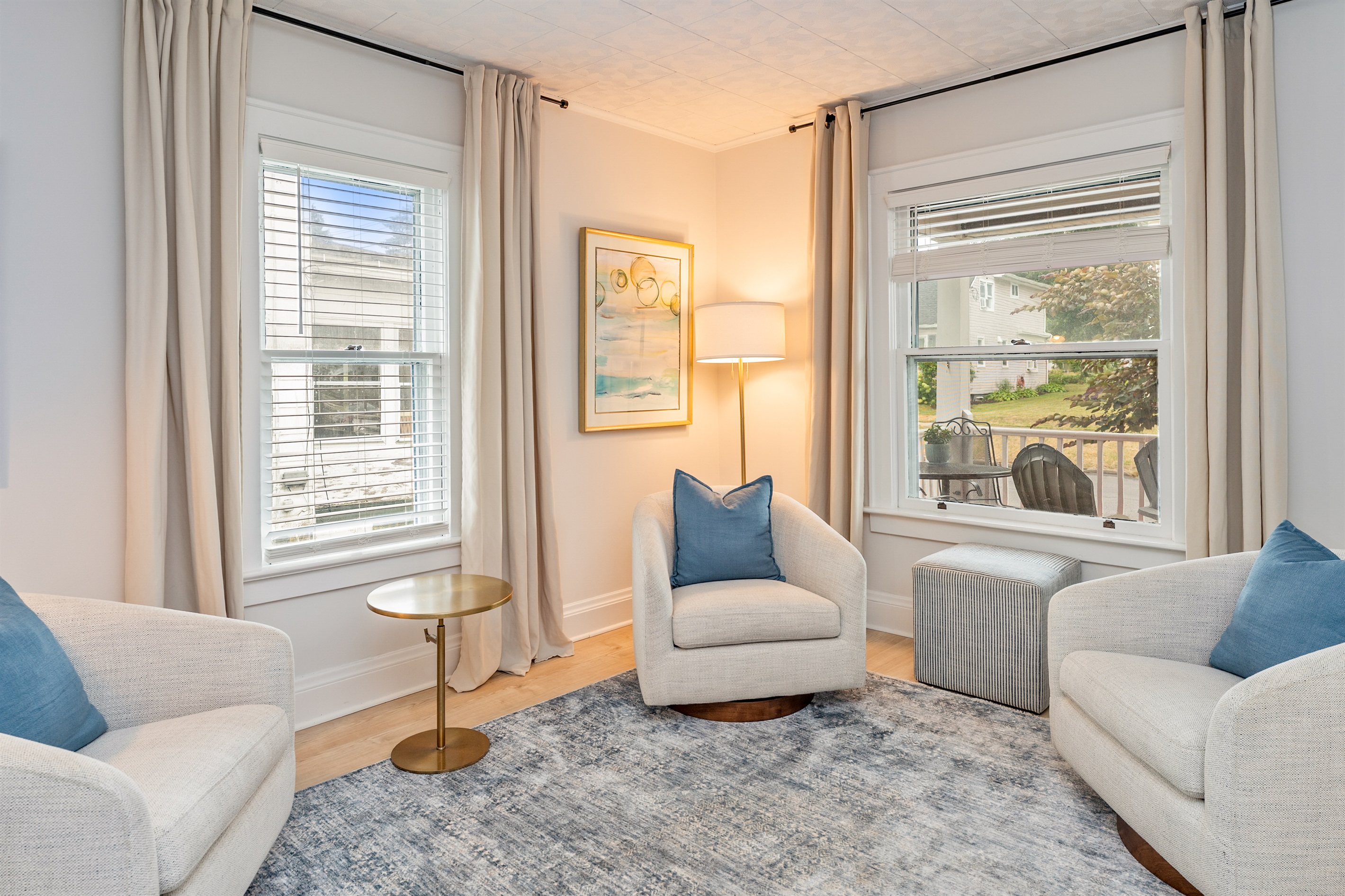 Enjoy morning coffee or a board game night in this sun-drenched living room with cozy swivel chairs and curated décor.
