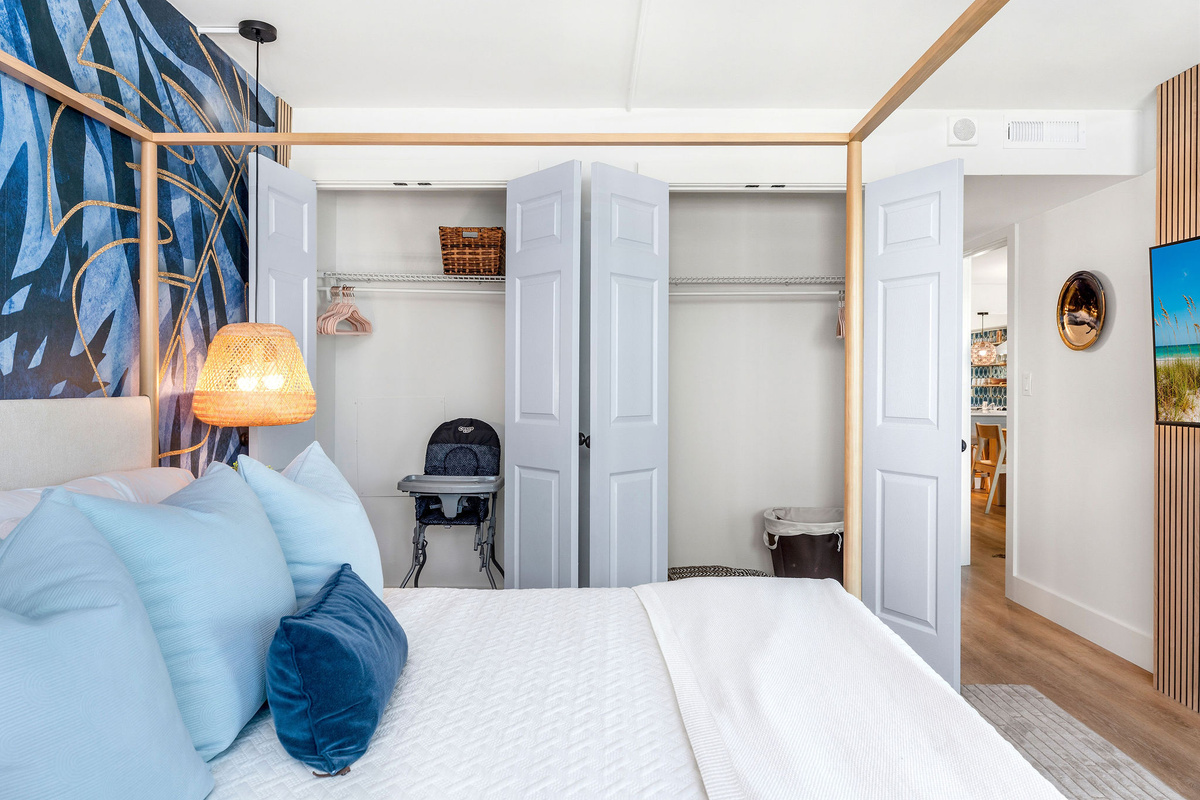 Read a good book in bed using the warm wall sconces and relaxing into all the fluffy pillows. The quiet ceiling fan keeps the room cool on warm nights. In the closet doors you'll find a pack-n-play, high chair, plenty of hangers and some laundry baskets.