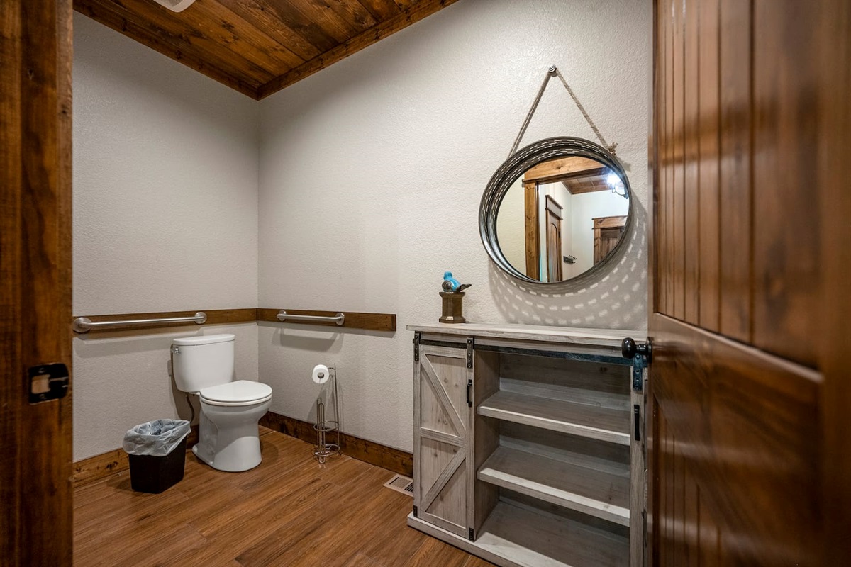 Primary bathroom features a wide doorway and handrails near the toilet
