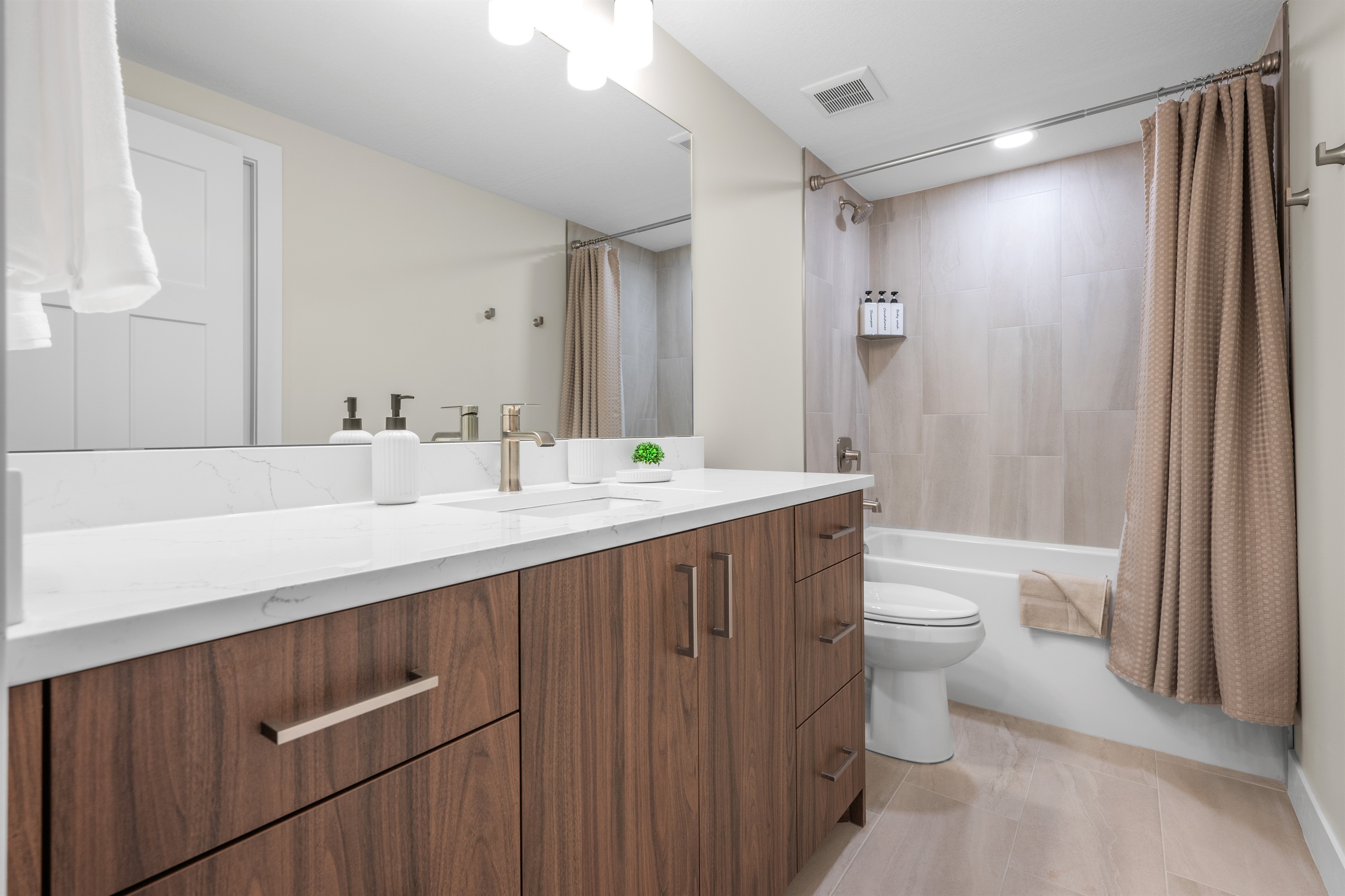 The ensuite bath has a combination tub and shower.