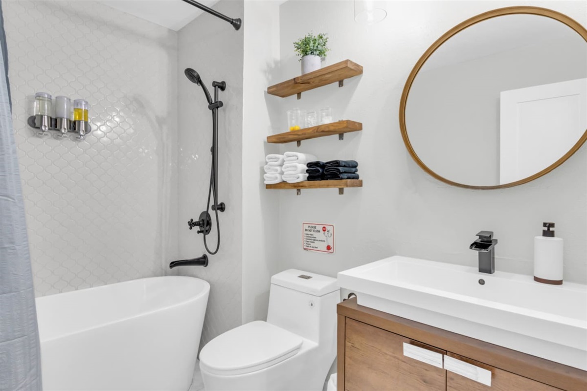 Spacious full bathroom with sleek finishes and plenty of room to refresh