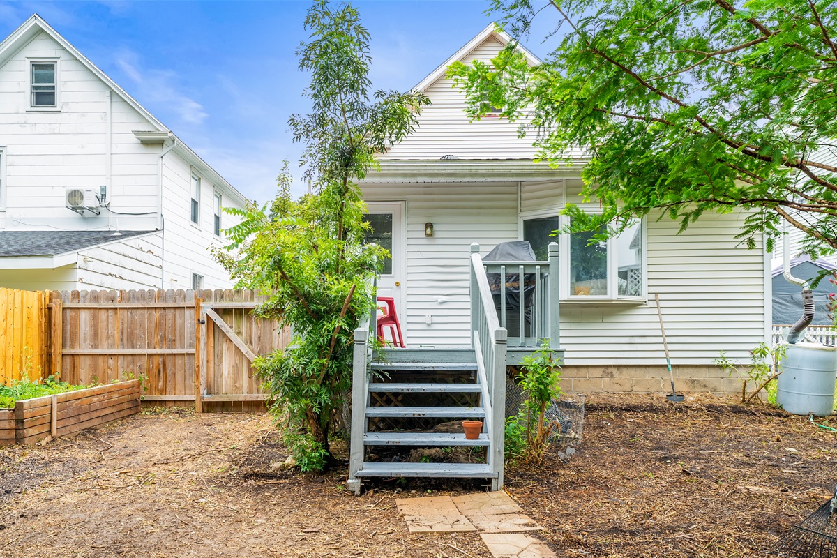 Step out from the back door to newly graded yard and grill area—your own urban escape!
