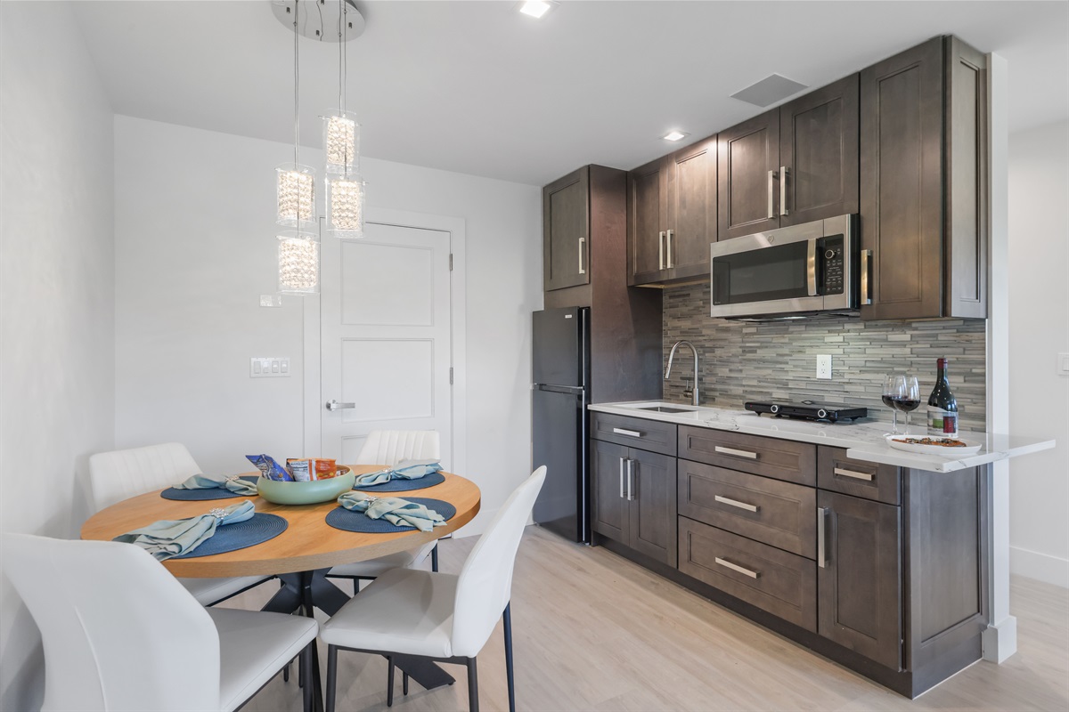 Modern kitchenette – refrigerator, cooktop, and microwave-convection oven for easy meals.