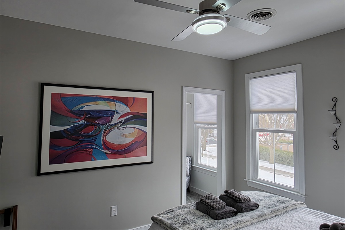 Queen Bedroom 3: Relax on a plush bed adorned with vibrant pillows and gentle natural light