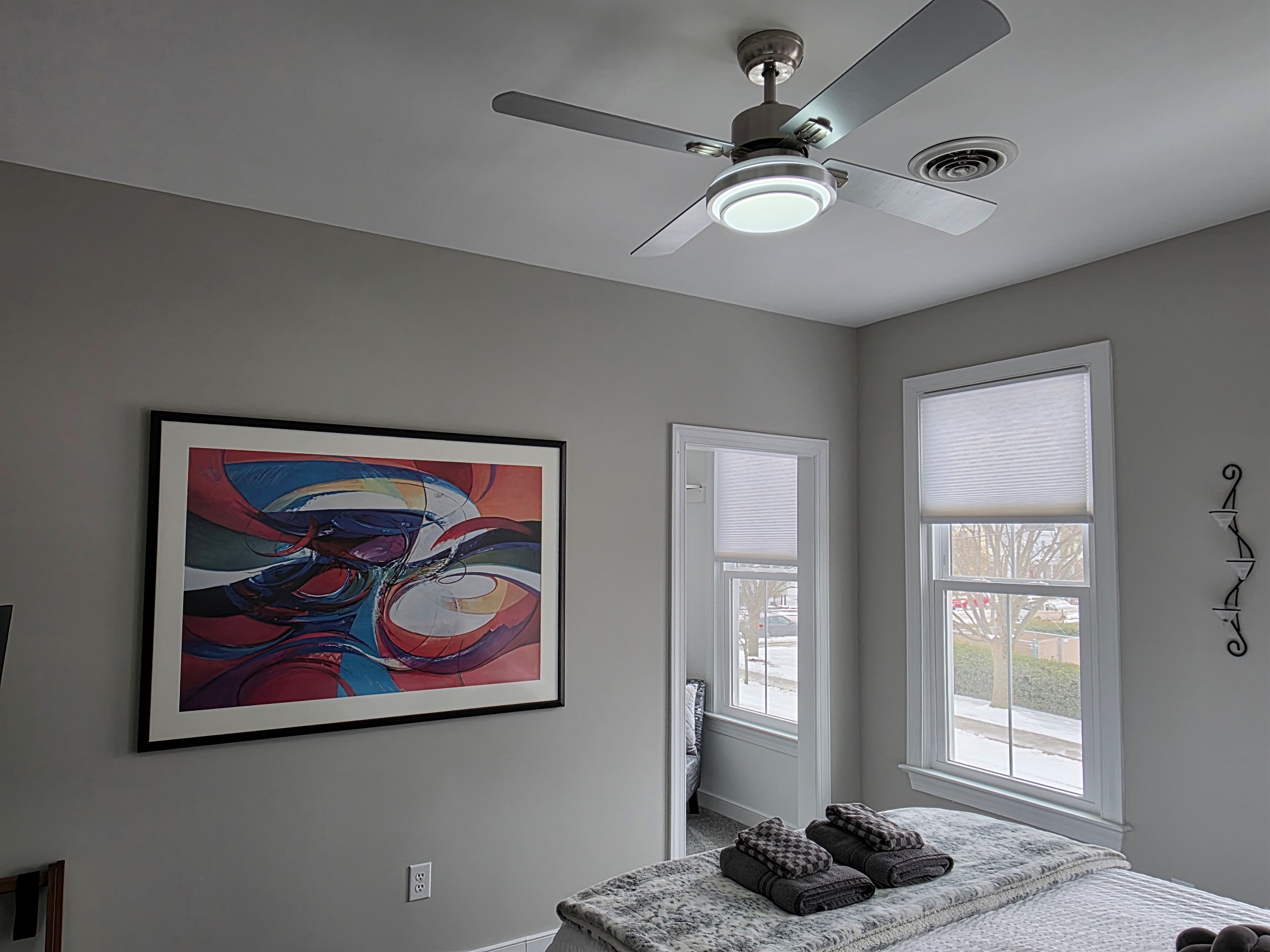 Queen Bedroom 3: Relax on a plush bed adorned with vibrant pillows and gentle natural light