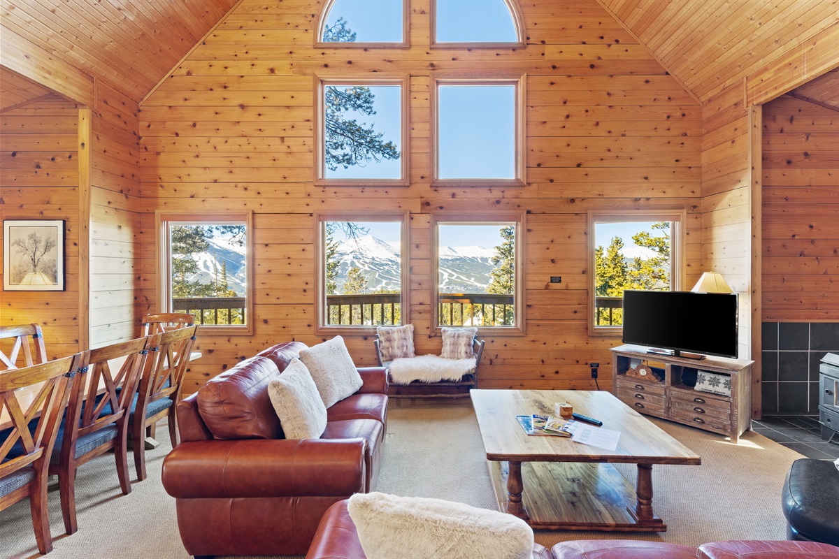 Great room with dining on left, living in center, wood stove on right
