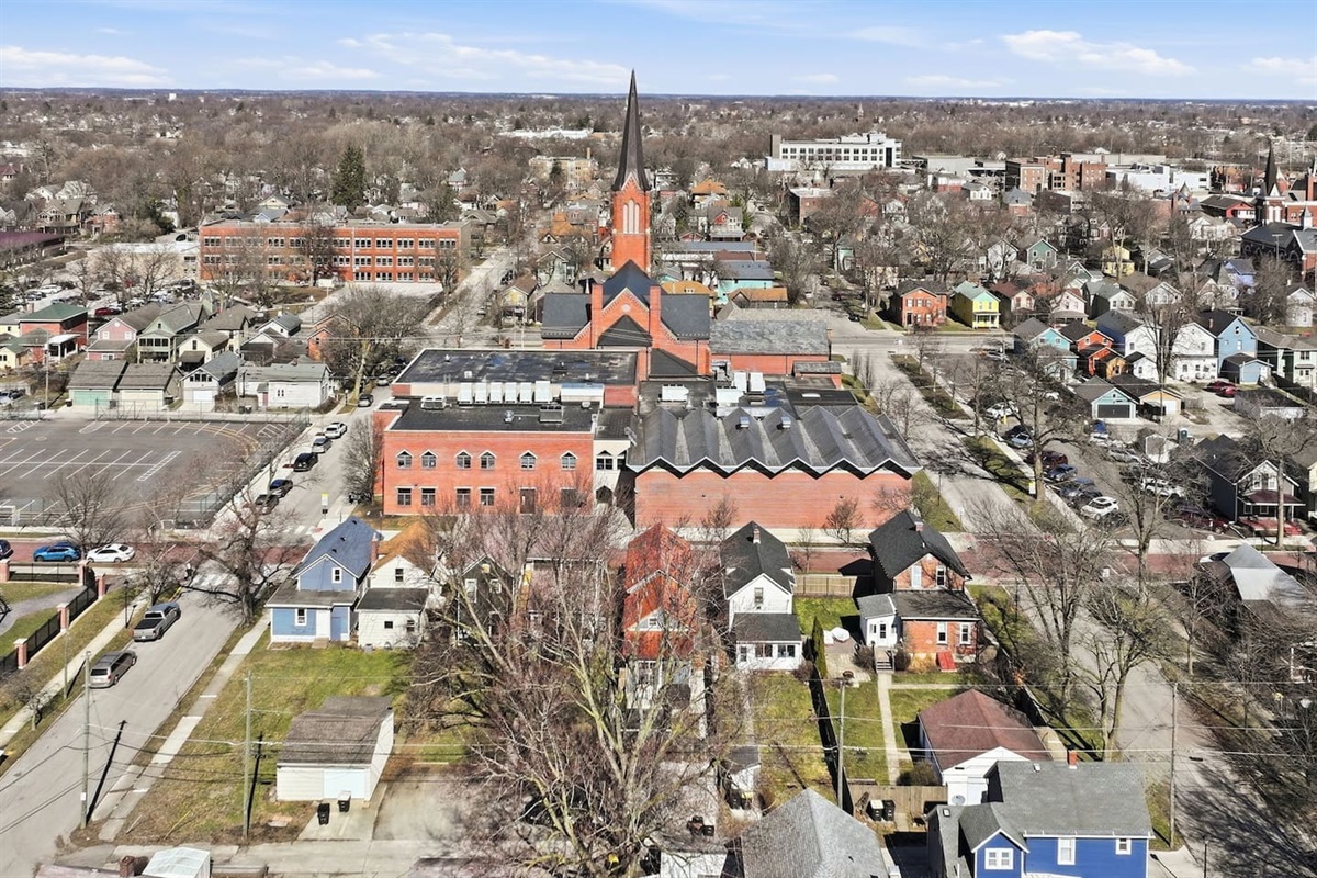 Aerial view highlighting the home’s proximity to a charming neighborhood and local landmarks
