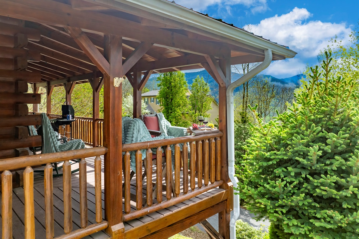 Porch Paradise: Unwind on the spacious deck with stunning mountain views and inviting seating!