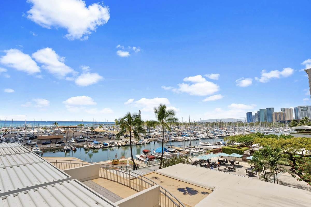 View from your lanai -- Waikiki yacht harbor, ocean and gorgeous sunset views right from your private balcony!  