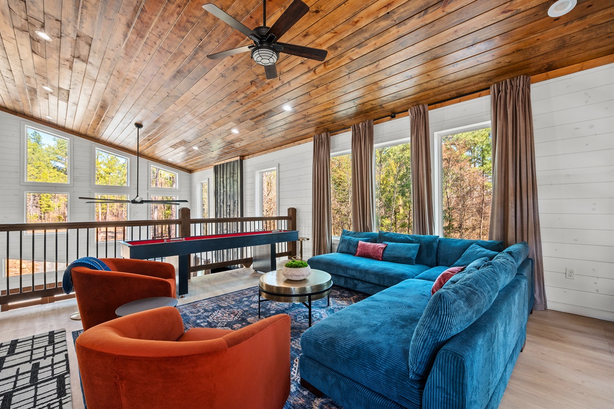The second-floor lounge provides a cozy retreat with beautiful wood accents and plenty of natural light.