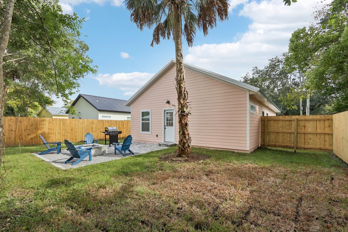 Outdoor firepit with 4 Adirondack chairs, BBQ grill, and outdoor picnic table