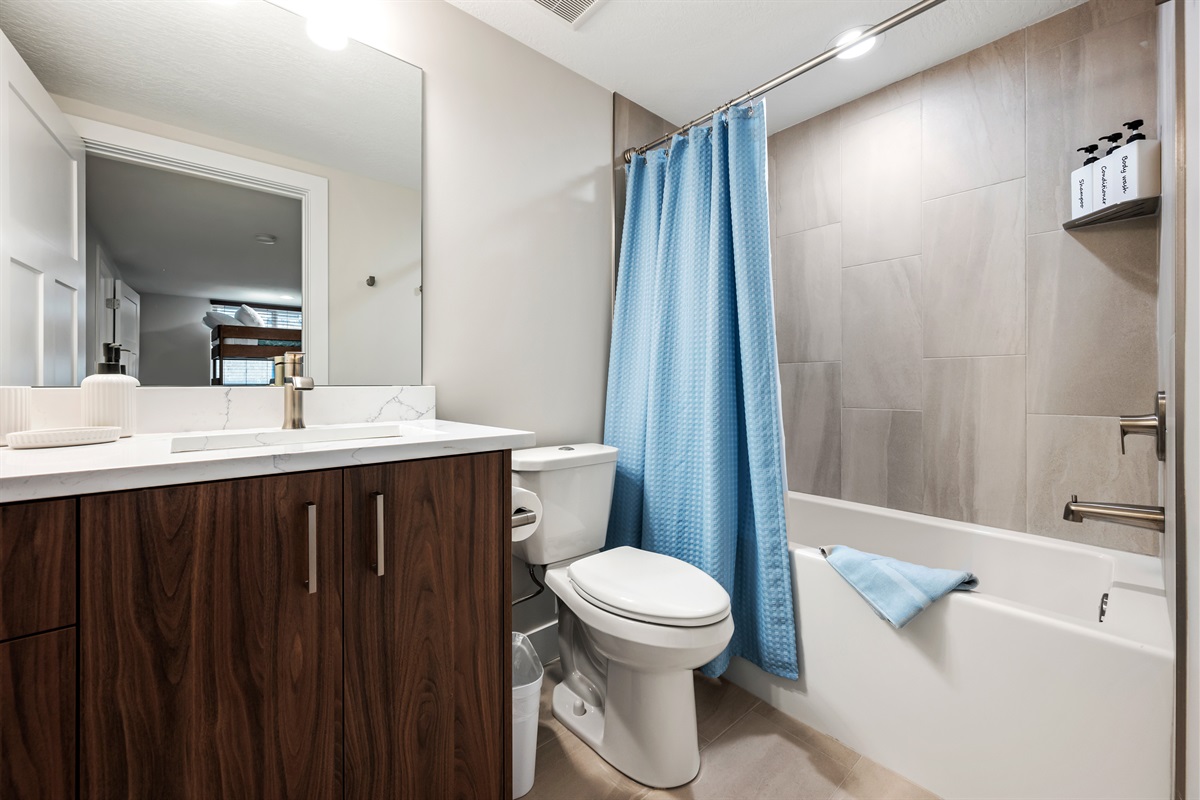 The Bunk room bathroom has a combination tub and shower.