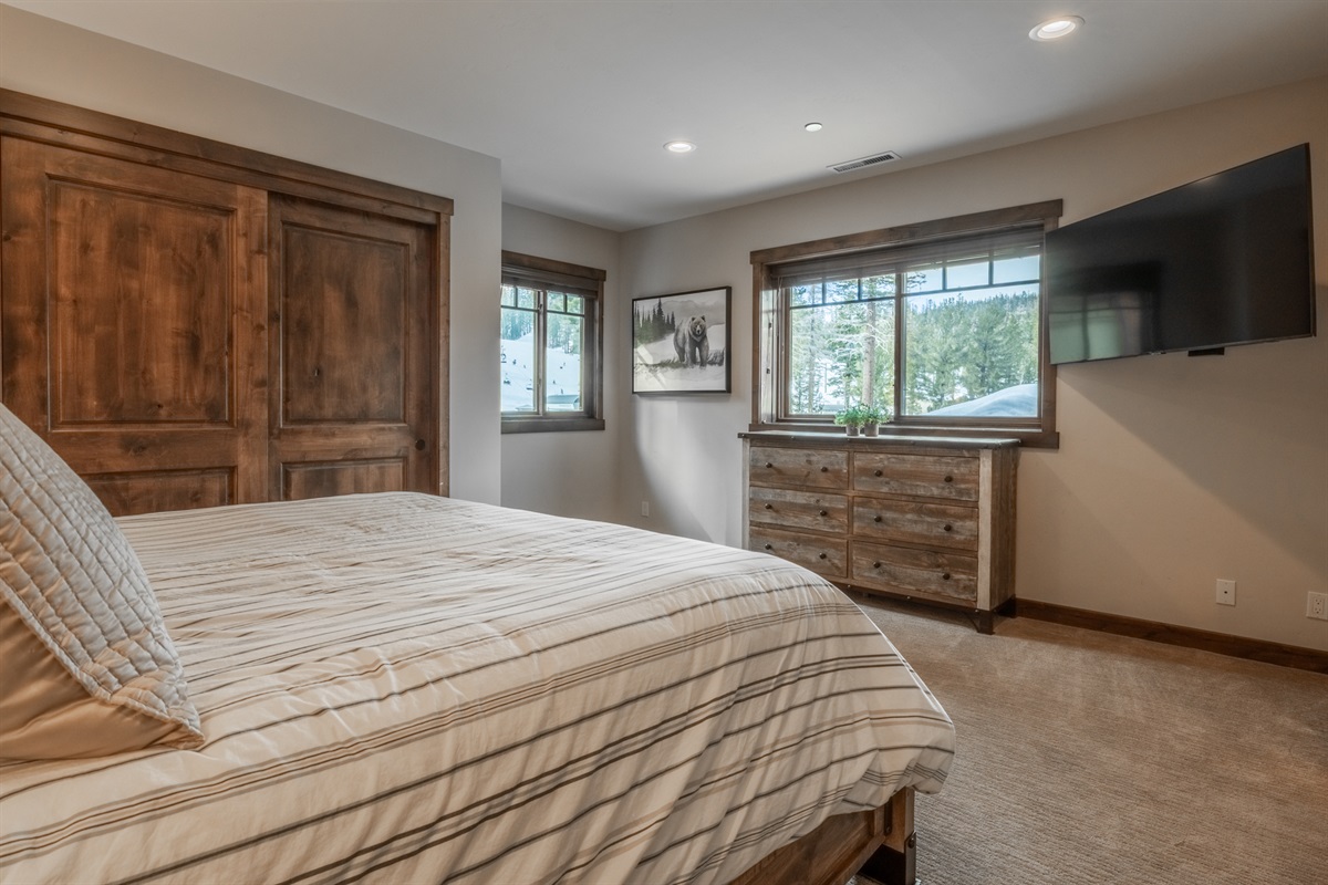 Perched on the top level for added privacy, the primary suite offers beautiful natural light, elevated views, and a serene alpine feel.