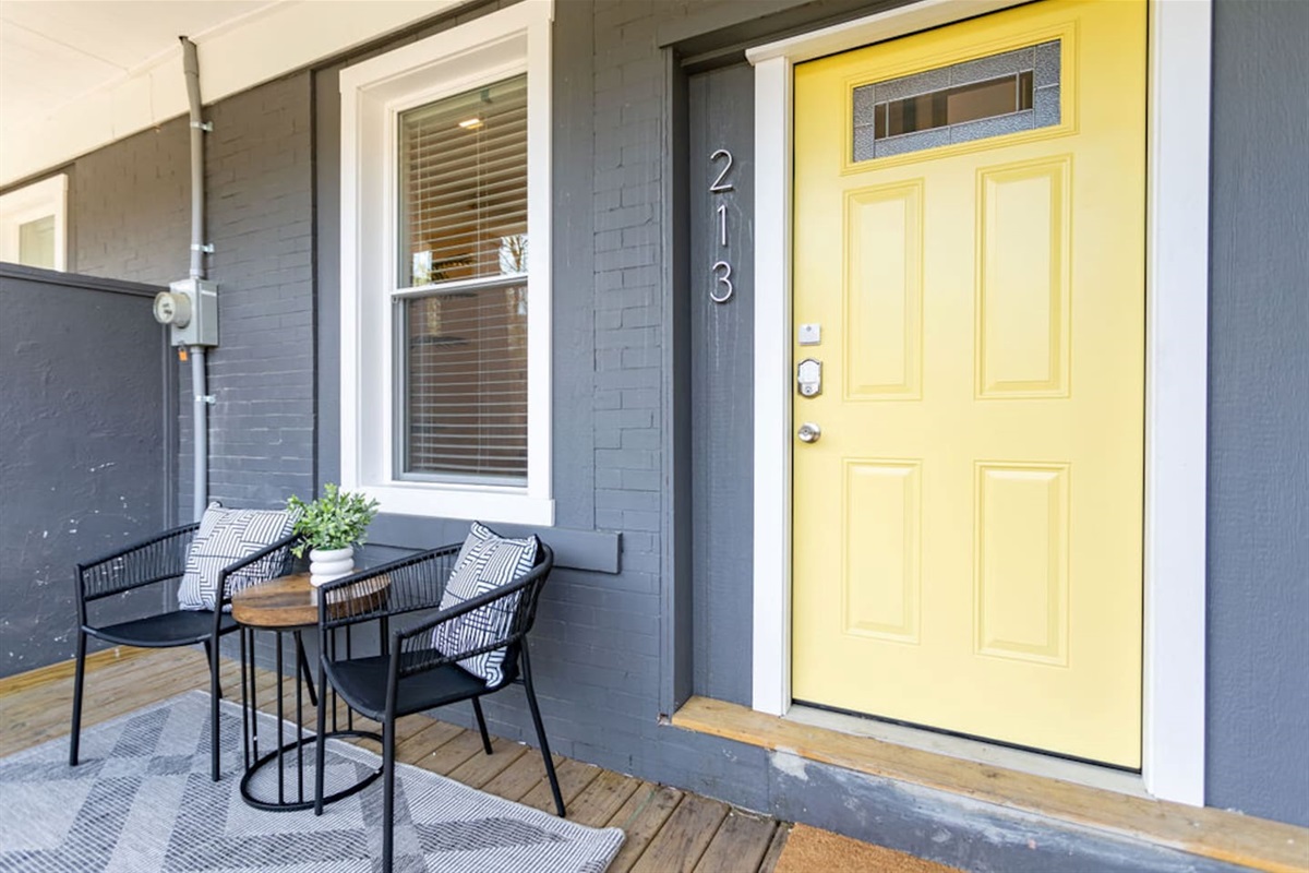 Front entrance patio with a welcoming door, offering a cozy outdoor space to enjoy.