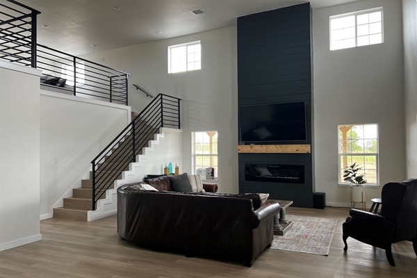 Living Room with 70" big screen TV and electric fireplace