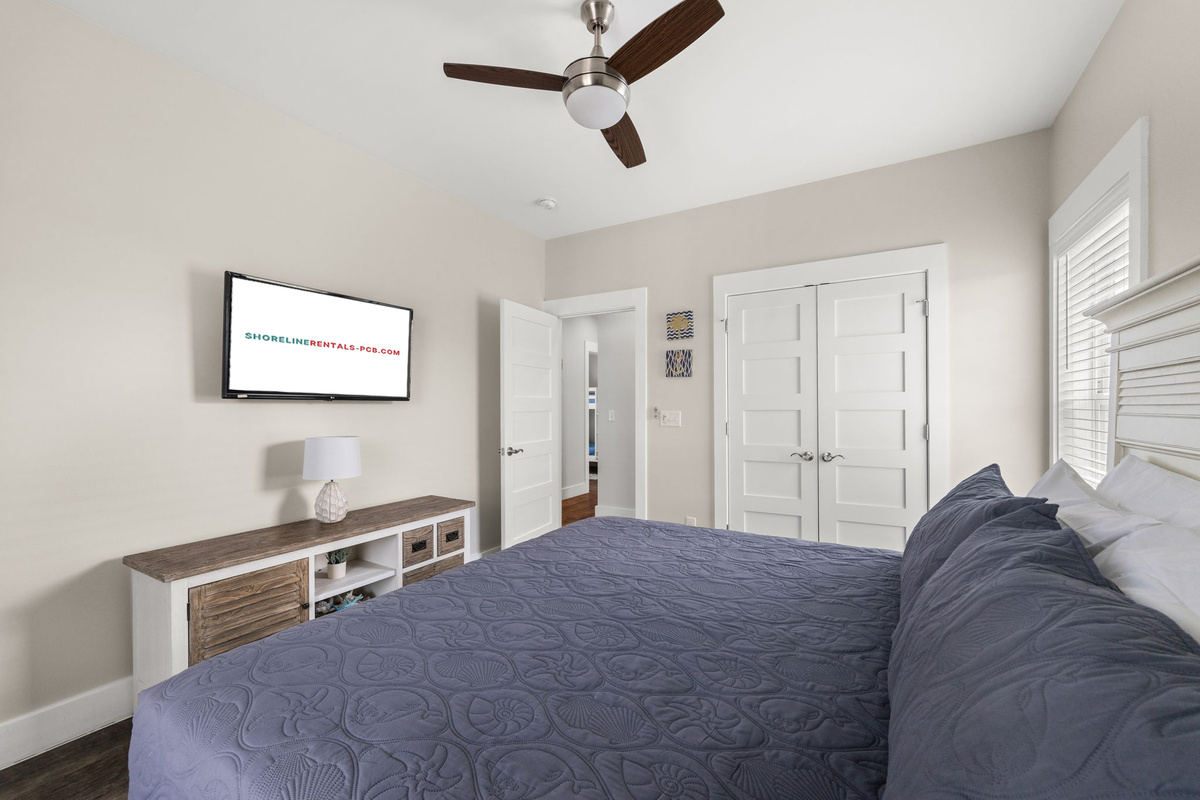 Additional second floor & 4th king guest bedroom with a smart TV and peaceful pool views