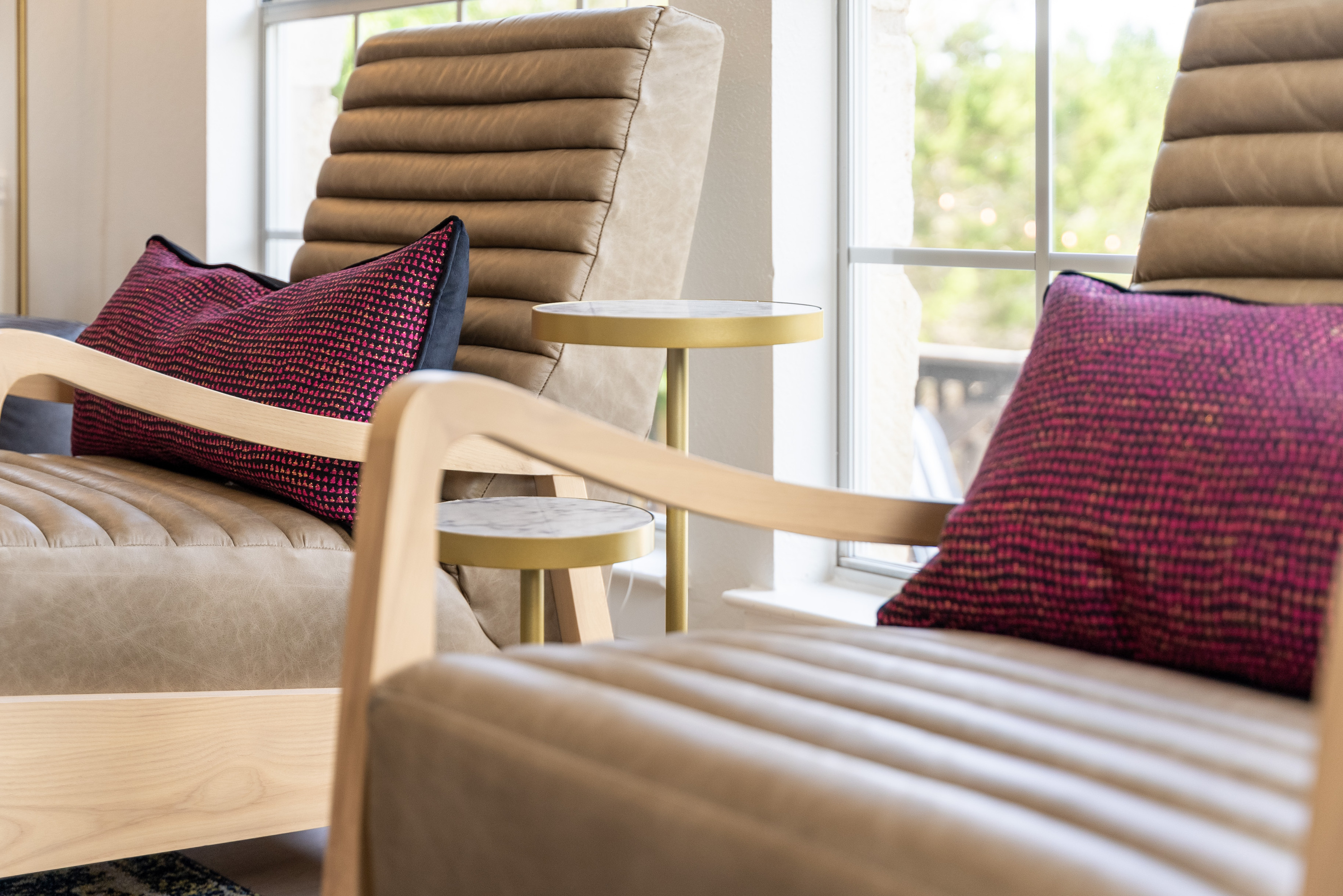 Cozy accent chair with bold pink and coral pillow accents.