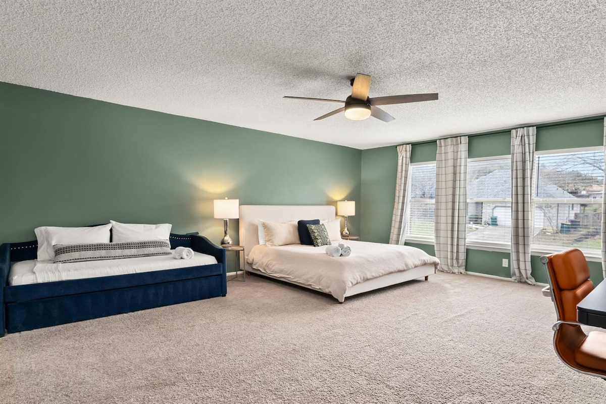The spacious master bedroom can comfortably accommodate four guests.