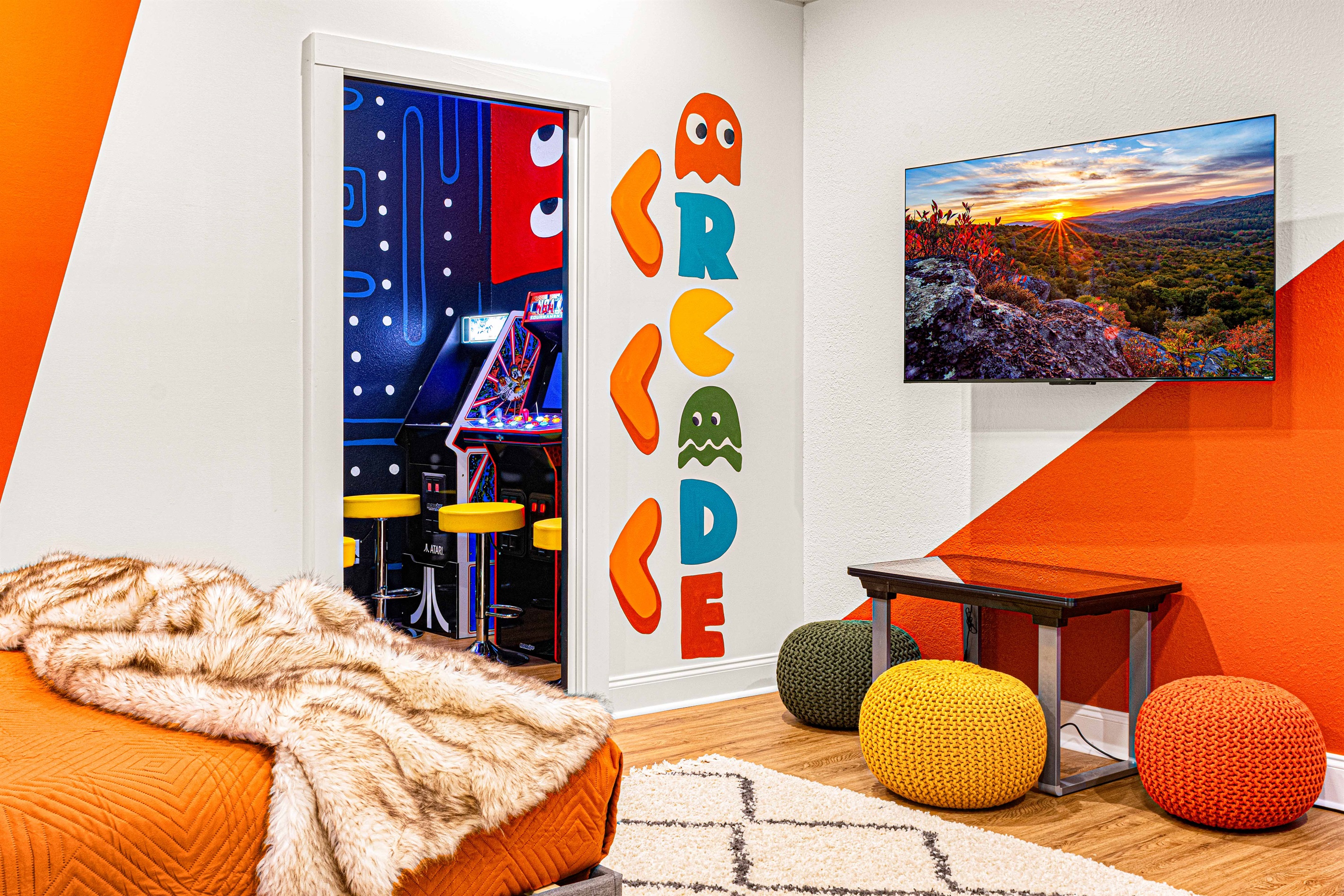 Enter our arcade corner, where fun meets nostalgia! 🎮✨ With vibrant Pac-Man murals, 6 classic standing arcade games, and comfy stools to relax on, it's the perfect spot to play. Plus, a pocket door connects it to Bedroom 5 for seamless entertainment! 🌟