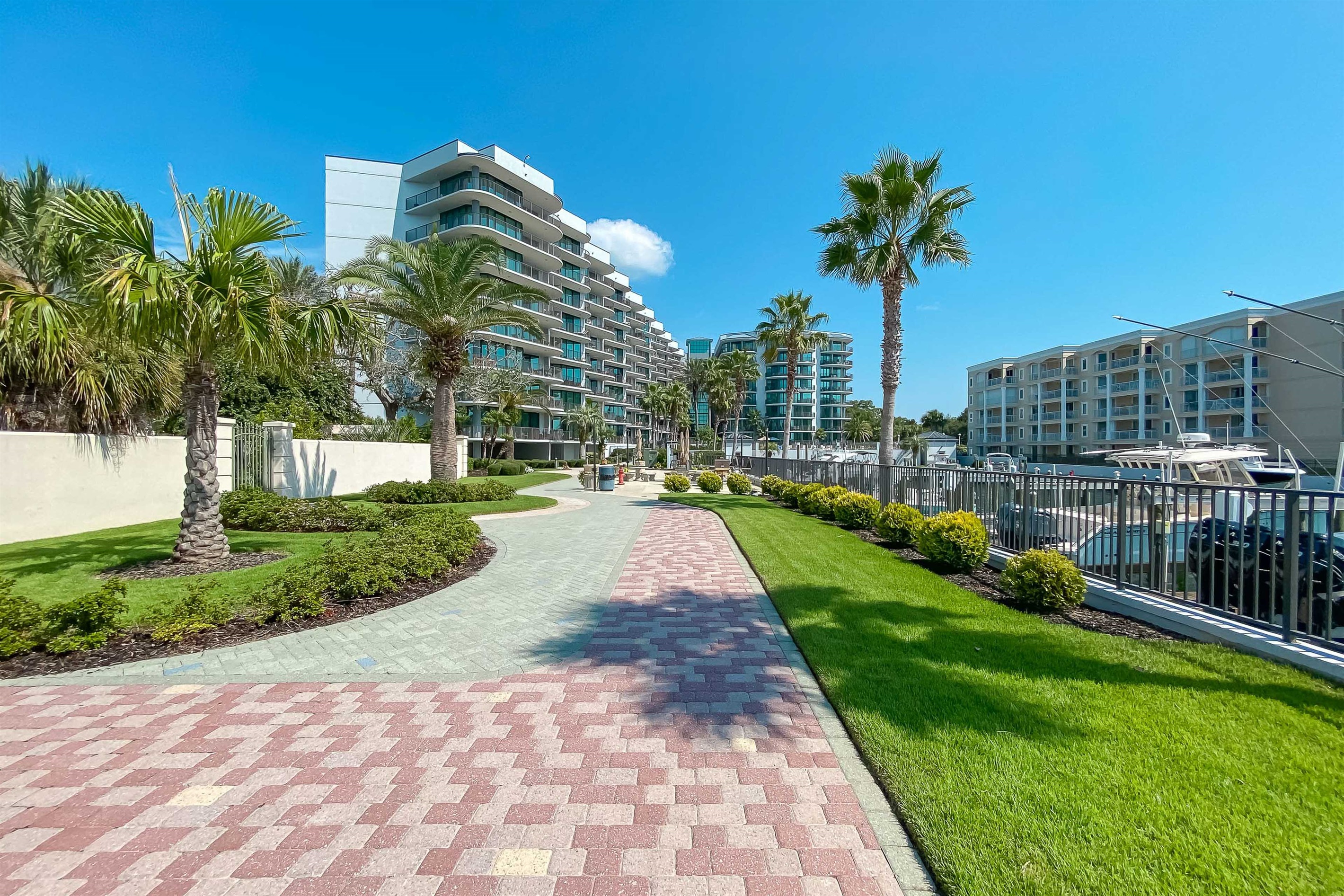 Stroll along beautifully landscaped pathways that wind through lush greenery and swaying palms, all while enjoying glimpses of the marina. Modern architecture meets tranquil waterfront living.
