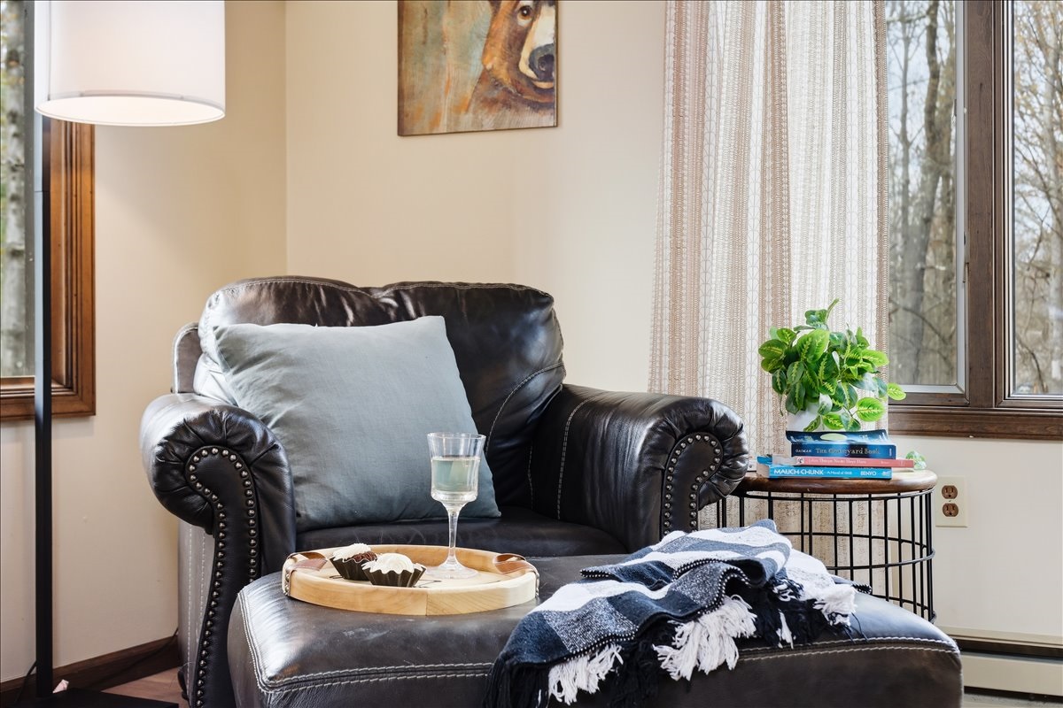 A leather armchair, a stack of books and a glass of wine, the perfect corner to disappear into