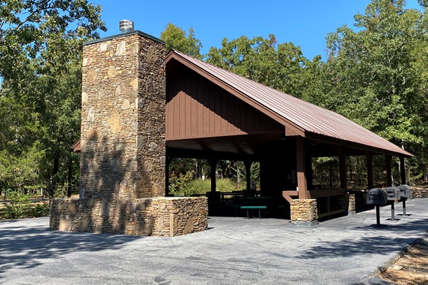This rustic pavilion is great for hosting outdoor meals or group gatherings, featuring grills and picnic tables.