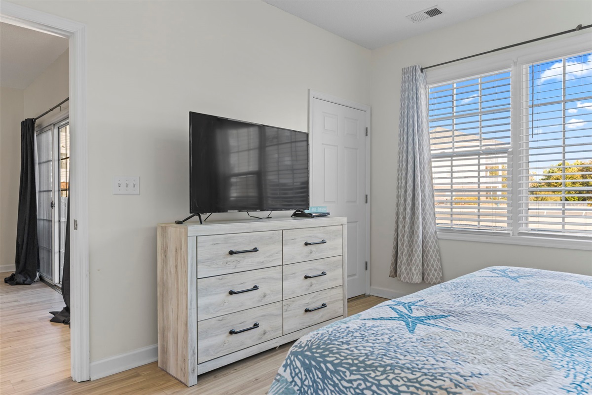 Master Bedroom with large window, king bed, ensuite bathroom