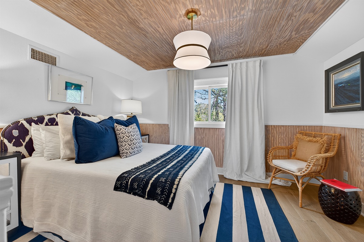 Cozy navy bedroom with layered textures and a plush full bed—designed for restful, boutique-style comfort on the 2nd floor