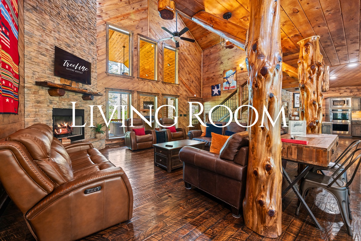 The main living area invites everyone to gather with plush seating, rich wood finishes, and a cozy atmosphere perfect for relaxing together.