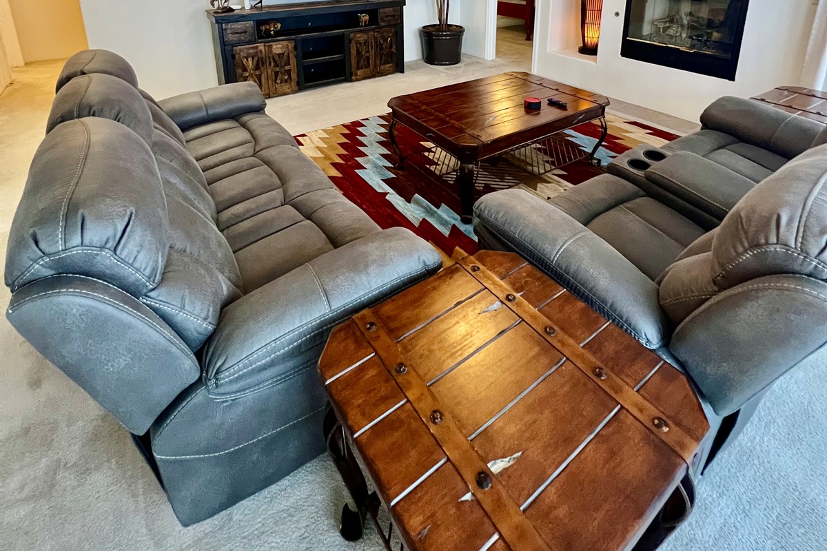 This expansive living room offers plenty of space for everyone to spread out and relax. Whether you're curling up by the fire with a good book, watching a movie on the  60-inch Smart TV, or enjoying game night with friends, this space has it all