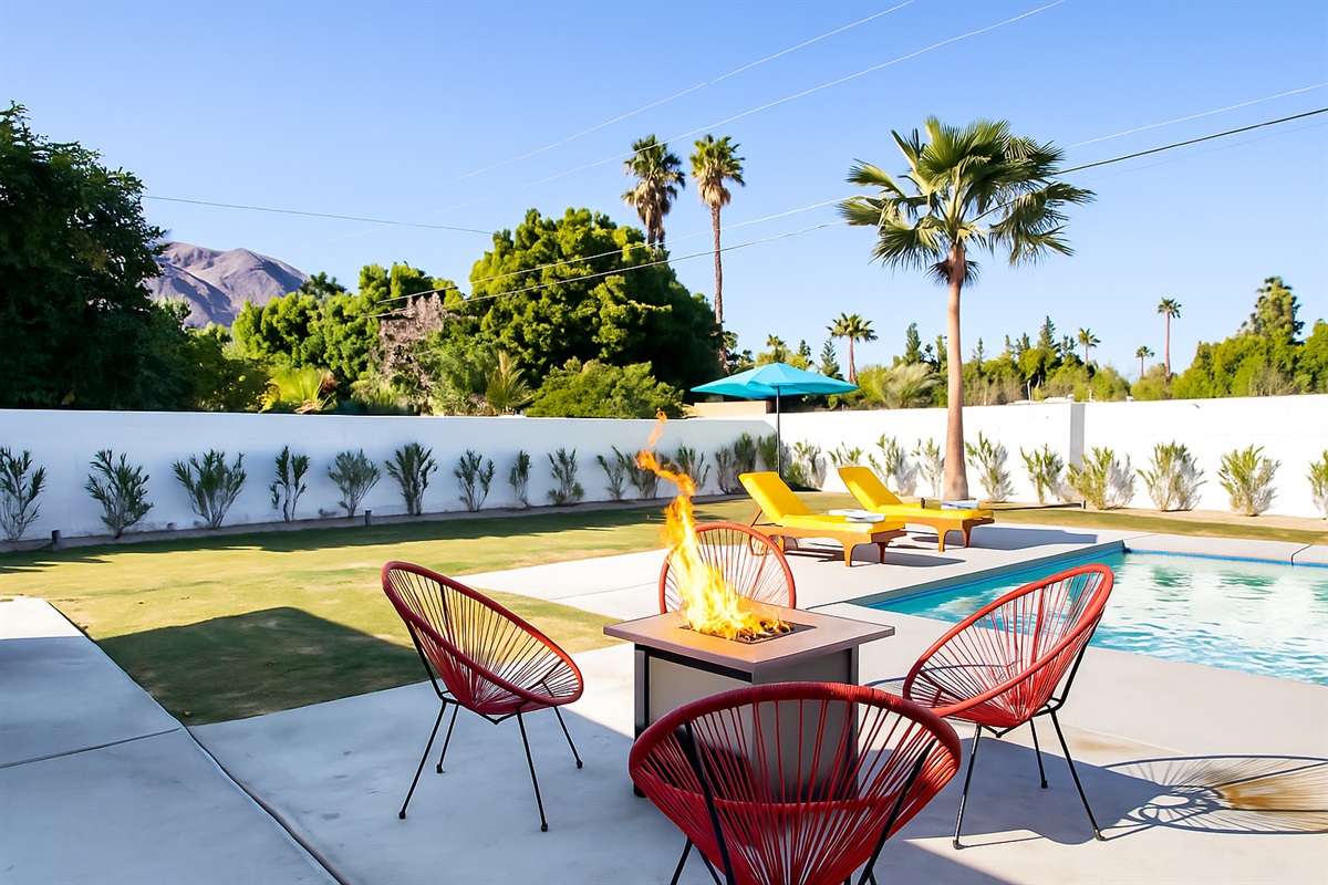 Escape to your private desert oasis — lounge by the sparkling pool, sip drinks by the fire pit, and soak in stunning mountain views under the palm trees!