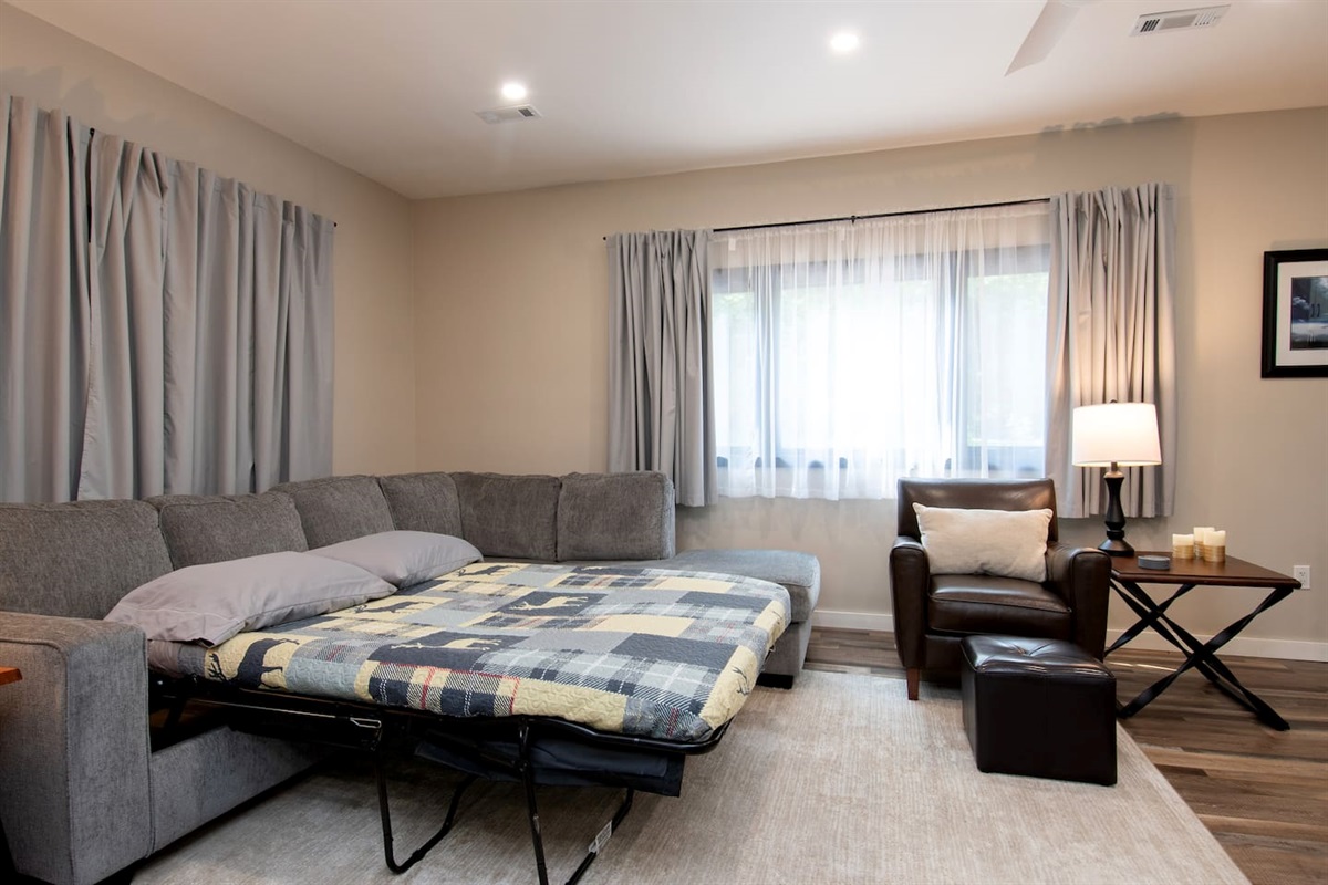 The is plenty of space to move around the queen size sofa bed. There are room darkening curtains and a ceiling fan.