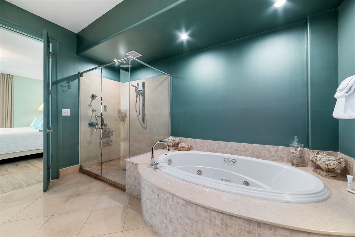 Indulge in the seamless flow between the luxurious primary bathroom and bedroom. Featuring a spa-like soaking tub, elegant vanity with a glass vessel sink, and serene ambiance, this space offers a private retreat.