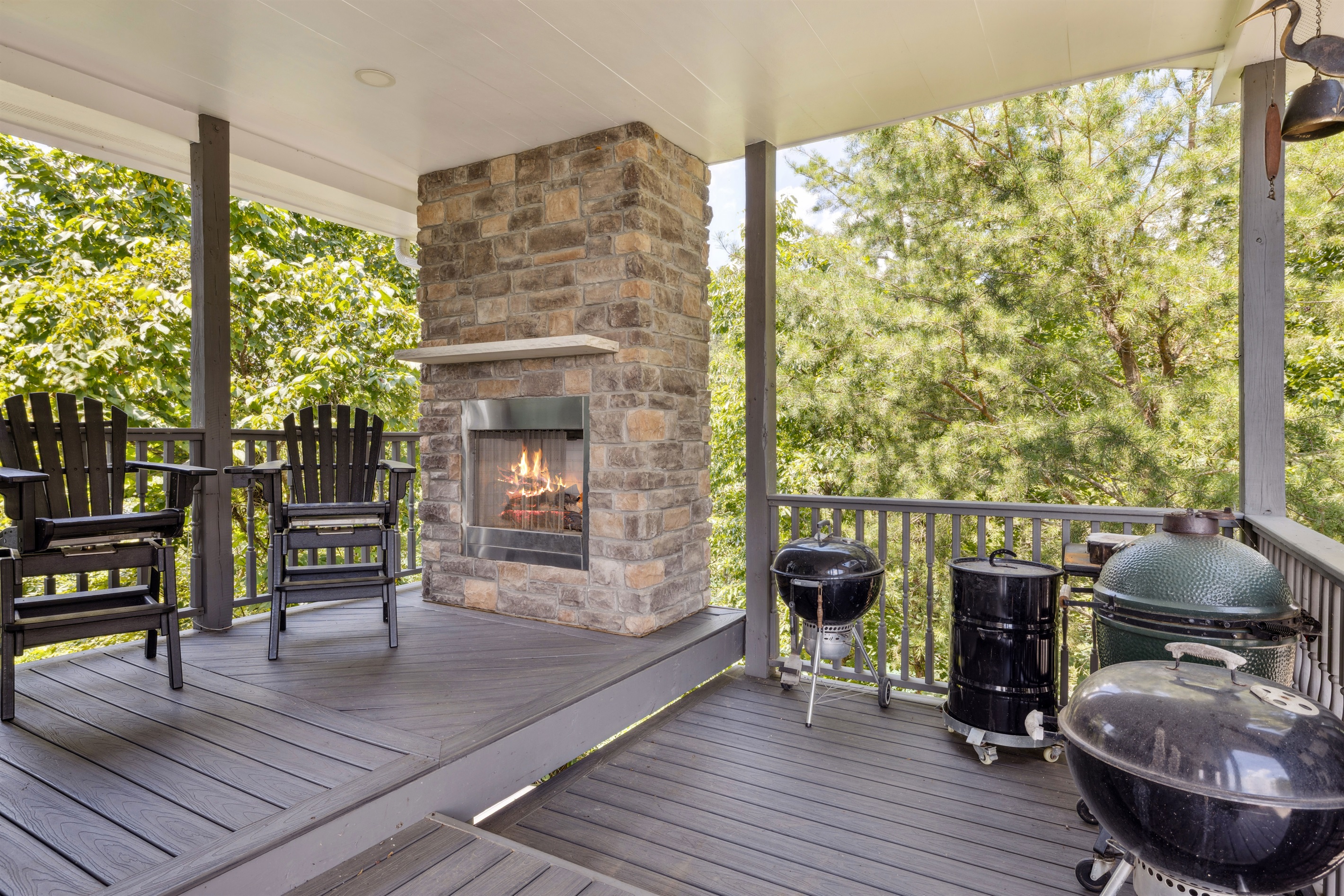 Grill deck with fireplace and seating area to the right of front porch