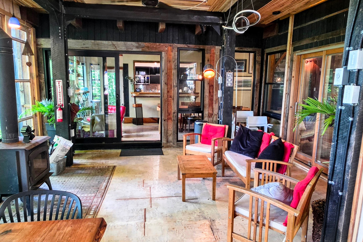 Veranda seating area closest to cottage doors with wood stove for winter use