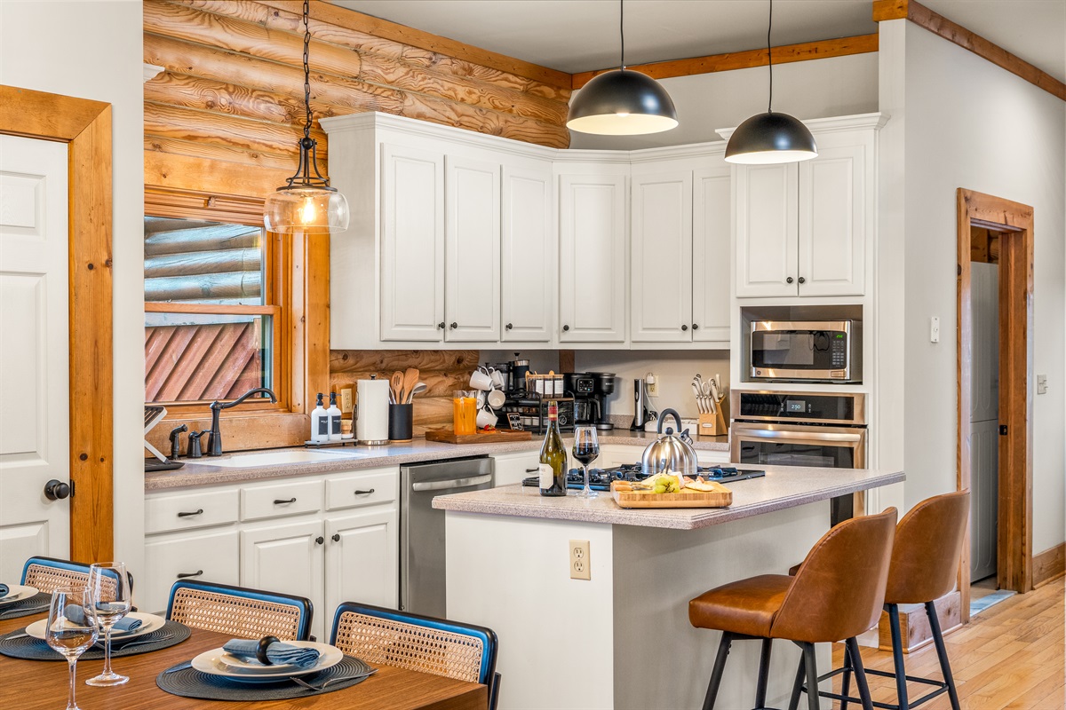 Gather for meals in the dining area with rustic cabin charm, plenty of seating, and natural light pouring in from the windows.