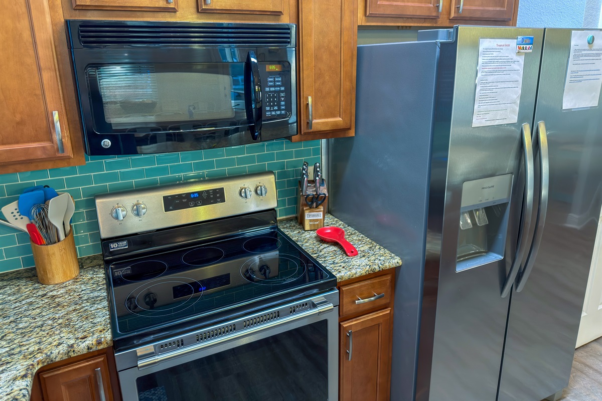 The gourmet kitchen combines coastal charm with ample prep space for preparing meals and entertaining with ease.