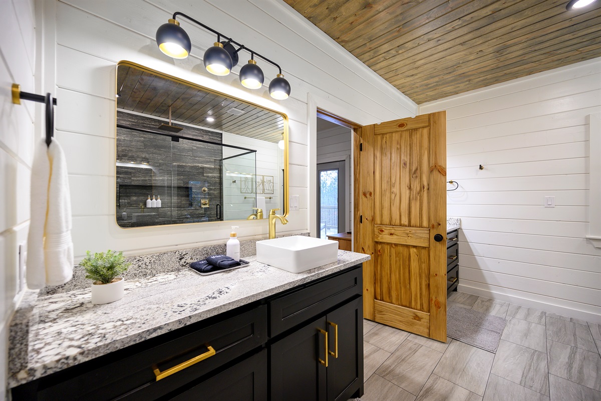 A complete bathroom setup featuring both tub and shower, providing flexibility and convenience throughout your stay