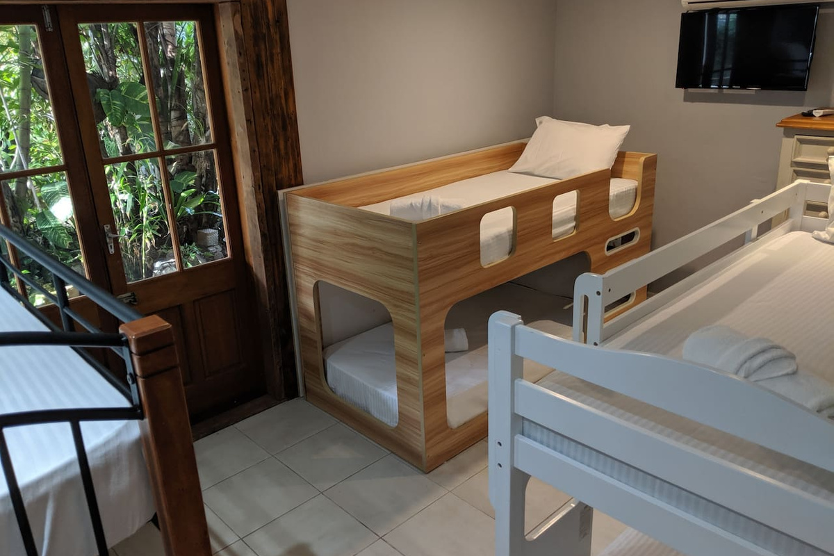 This bunk bedroom at Aaron's Beachside Boat House adds flexible sleeping space to the Marcoola accommodation layout, with timber finishes complementing the home’s coastal character.