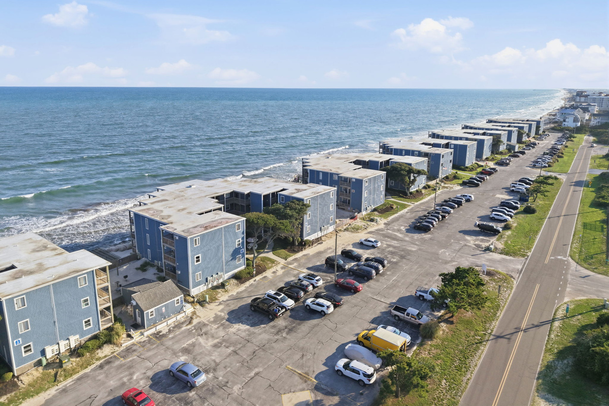 See the full stretch of Topsail Reef from above, showcasing the peaceful beachfront community, convenient parking, and the beautiful coastal surroundings of North Topsail Beach