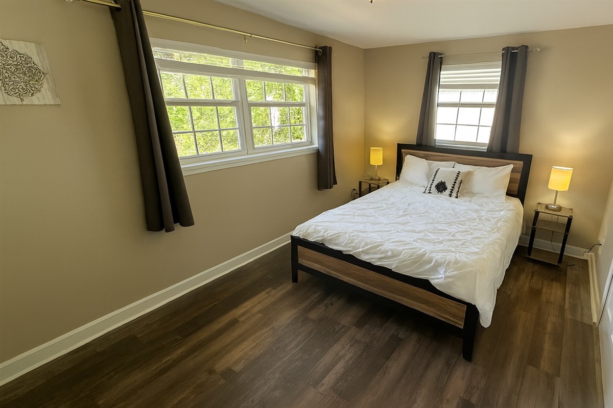Sunny bedroom with a cozy queen bed, stylish decor and reading nook—unwind after beach days at Madeira Beach and strolling Johns Pass from our Seminole midterm rental.