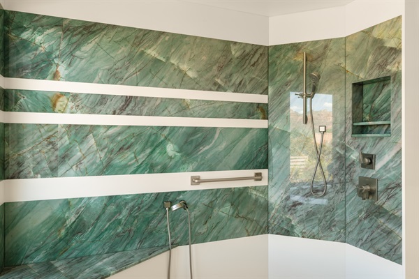 Rinse off the desert dust in our massive walk-in shower, featuring stunning floor-to-ceiling green marble, multiple showerheads, and premium Delta fixtures.