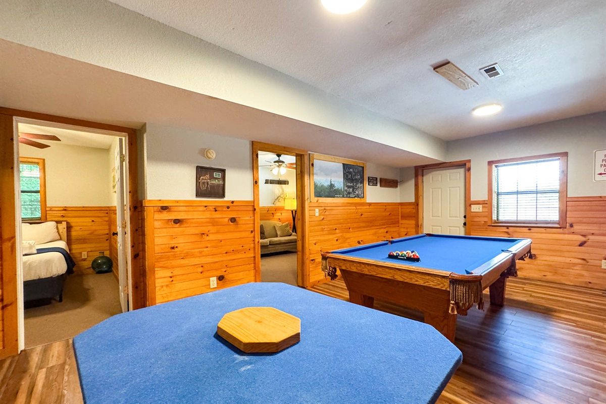 the lower level game room features a pool table and card table