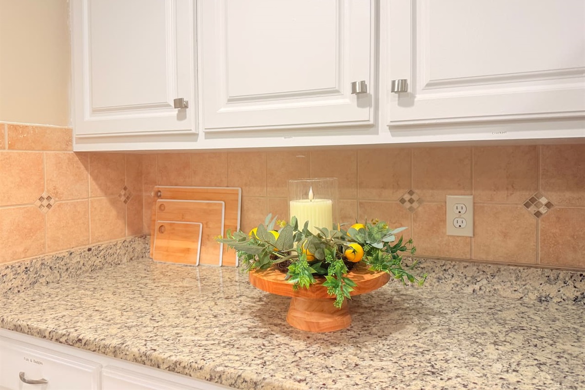Thoughtful decor touches throughout the kitchen add warmth and style to the fully equipped space.