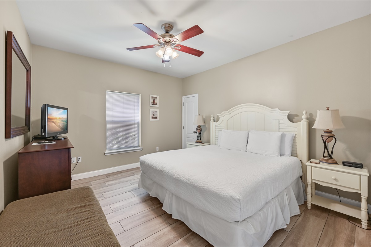 BEDROOM #1: King Bed with nightstands, dresser, and TV. (located on the 1st floor)
