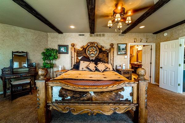 Feel like Texas Royalty in this Primary bedroom with rustic Texas-style decor, king bed, and warm, inviting finishes